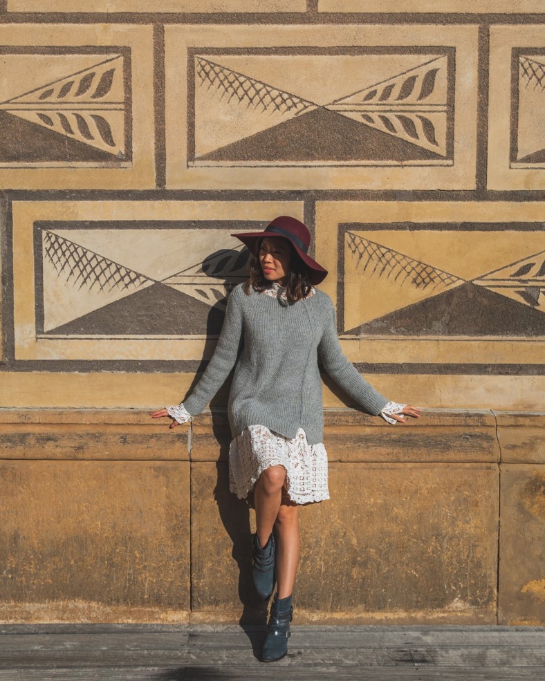 girl in front of wall near Schwarzenbersky Palace in Prague