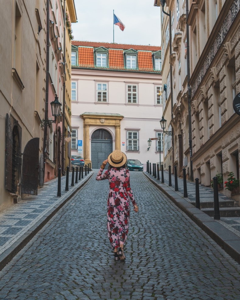 photo of girl on Nerudova Street during Sunrise