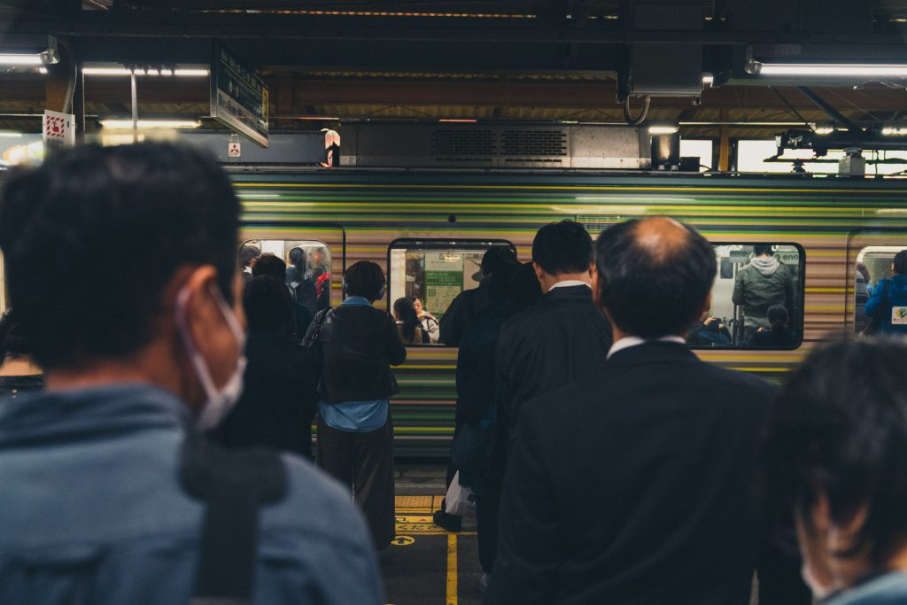 image of japanese workers in line for train