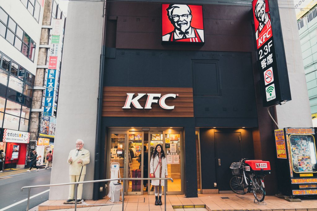 image of girl standing in front of kfc