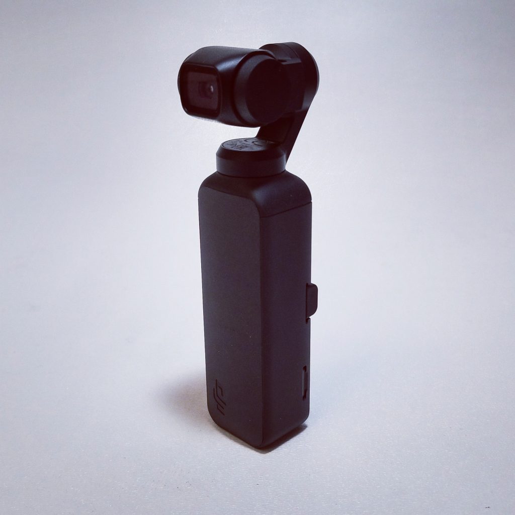 photo of black compact camera with gray background