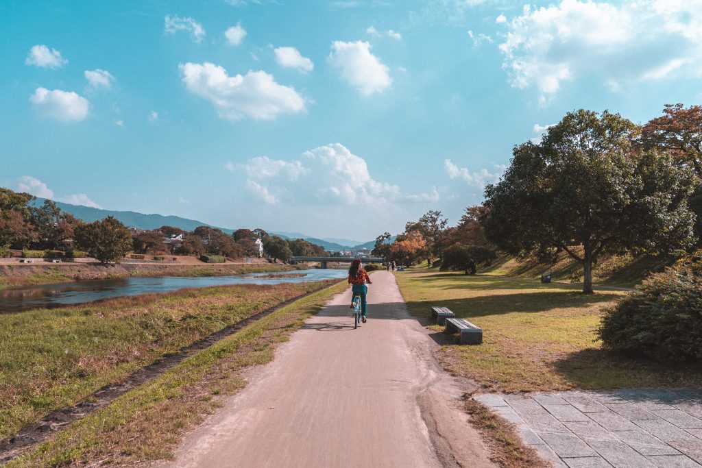 girl riding bike on empty road