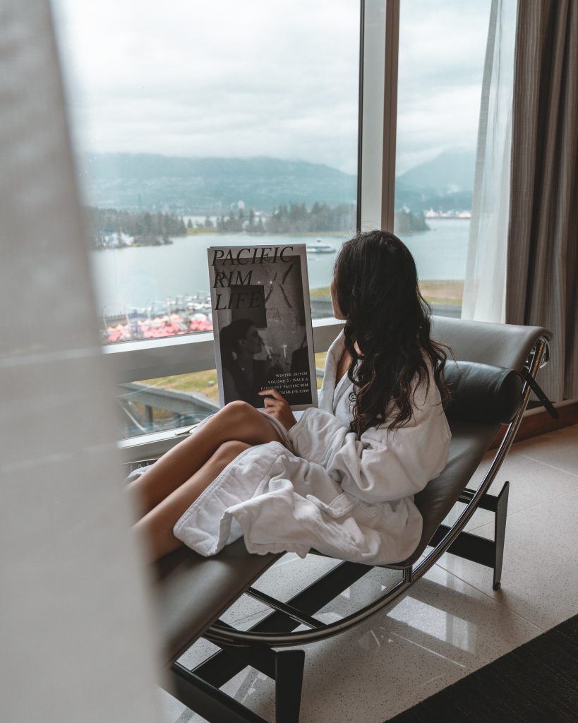 woman lounging in chair reading magazine