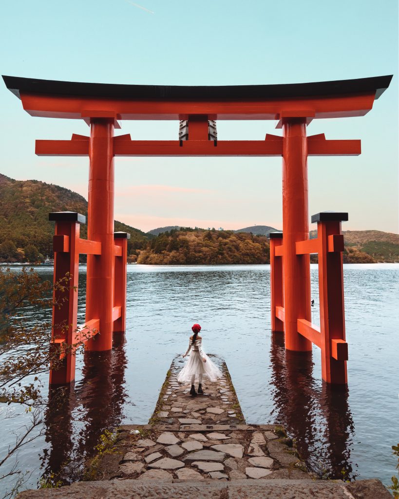 girl in front of Hakone red torii gate shrine