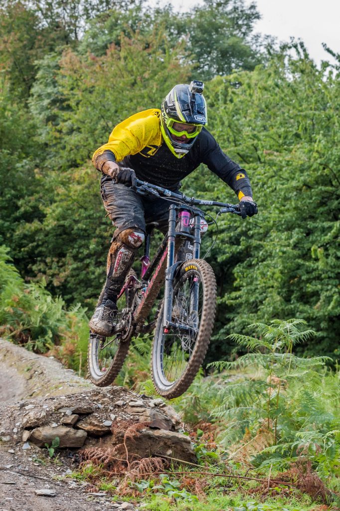 man riding on mountain bike with action cam on helmet