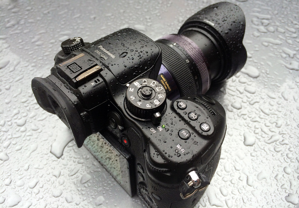 photo of black camera covered in water