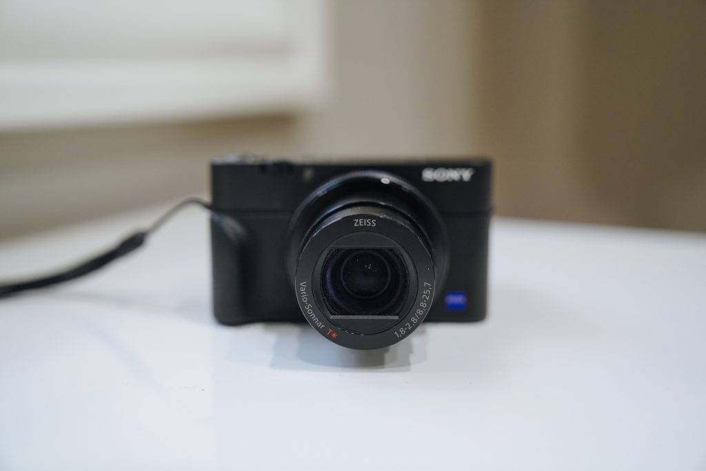 photo of compact black camera on white table