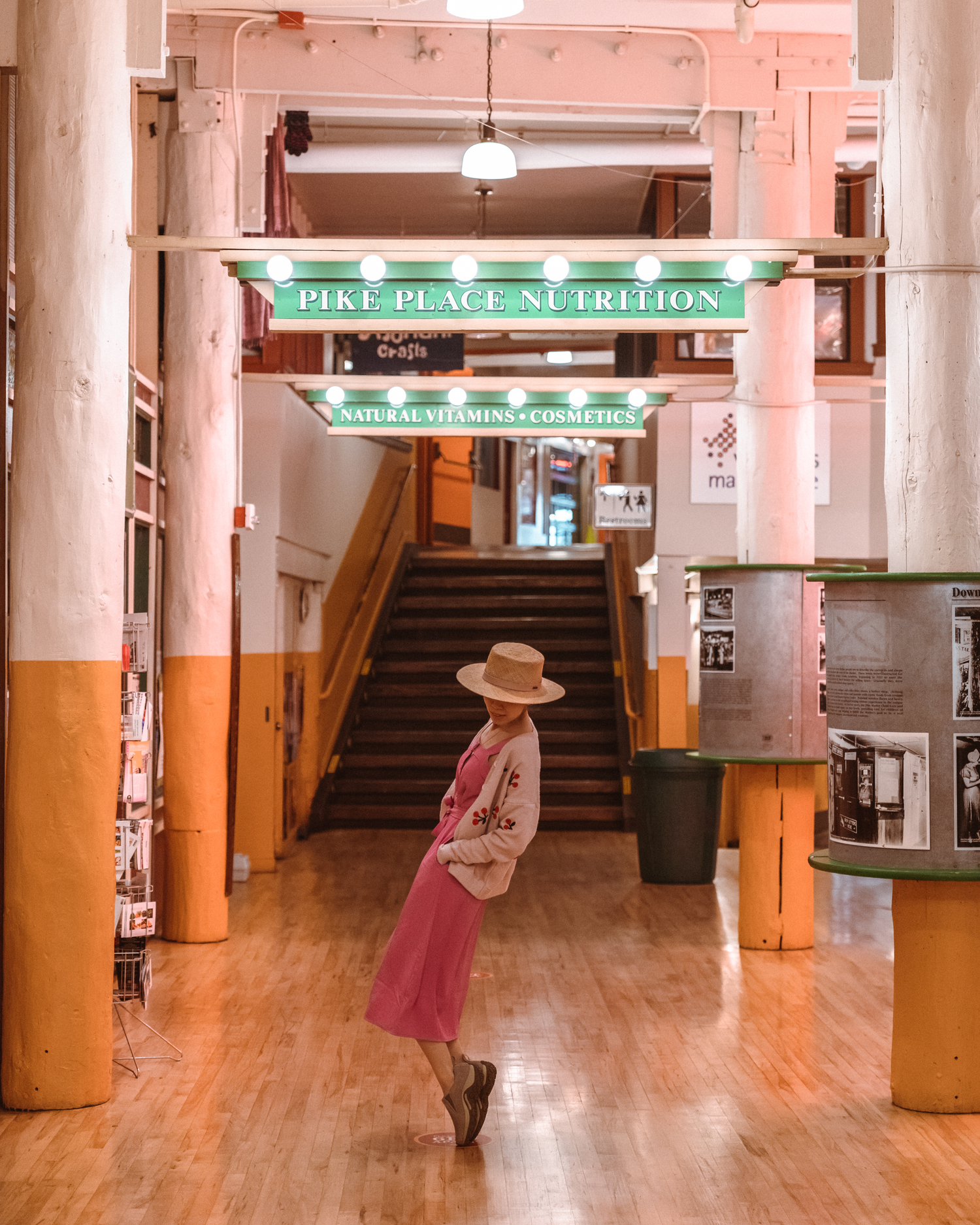 girl leaning back on tiptoes in Pike Place Market