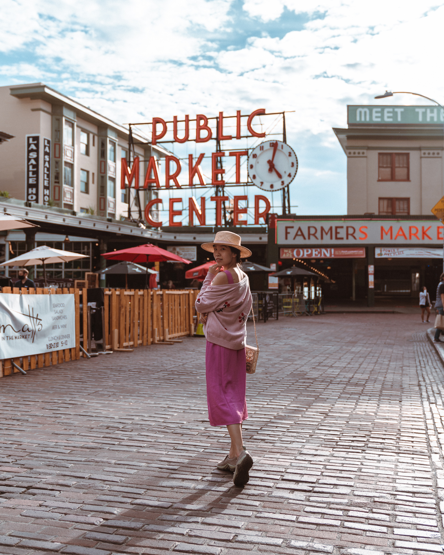 Girl in front of Pike Place Market sign