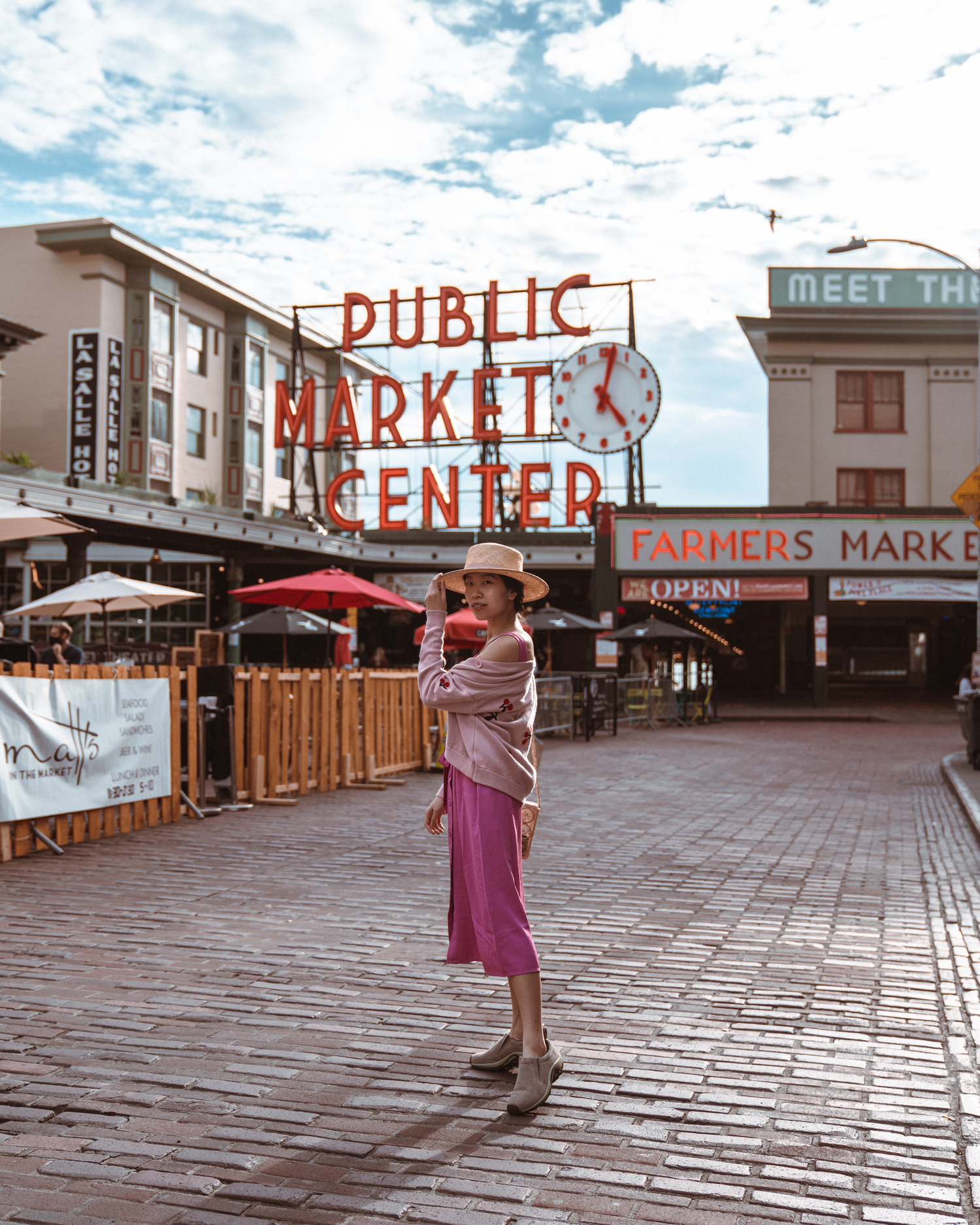 Girl in front of Pike Place Market sign