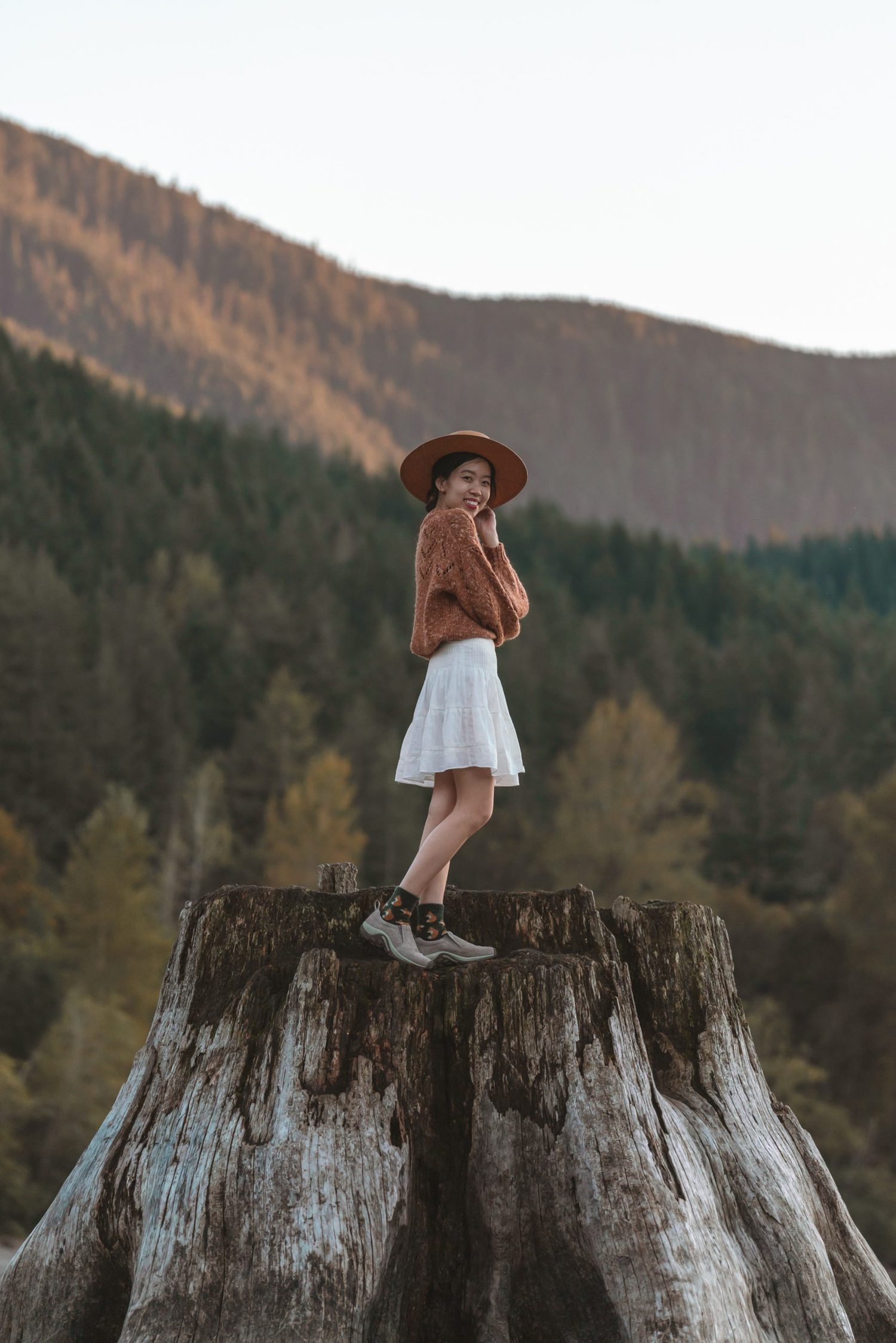 girl standing on tree stump at rattlesnake lake