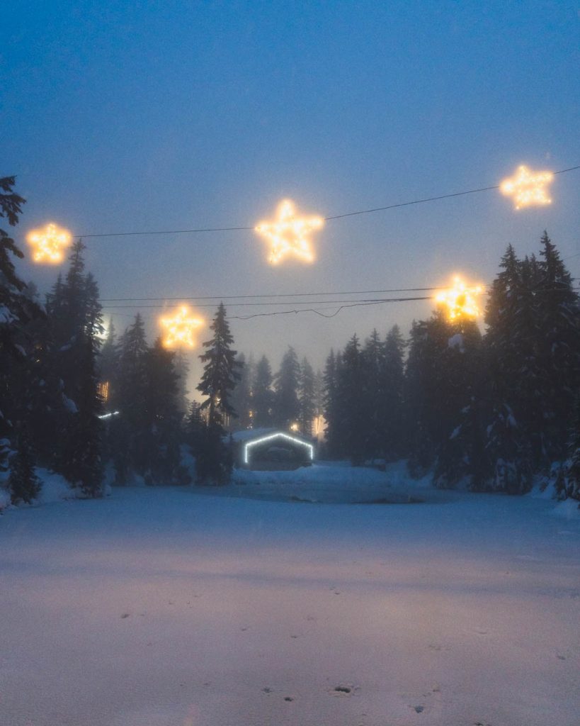 image of snow covered scene with house and lights that look like stars