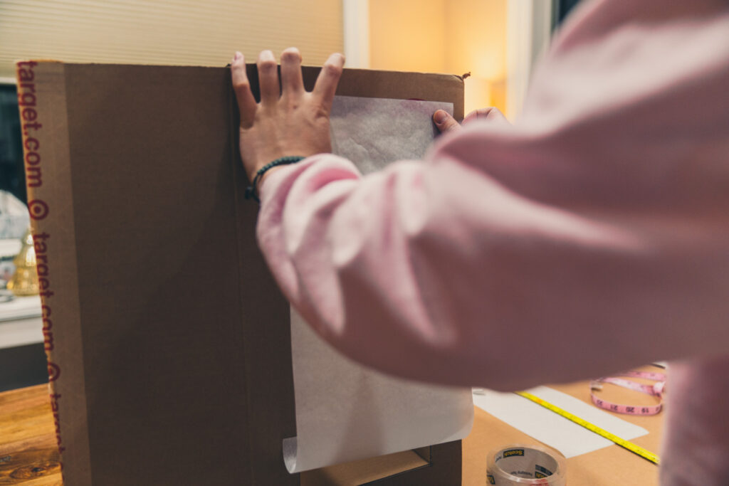 image of taping on parchment paper window