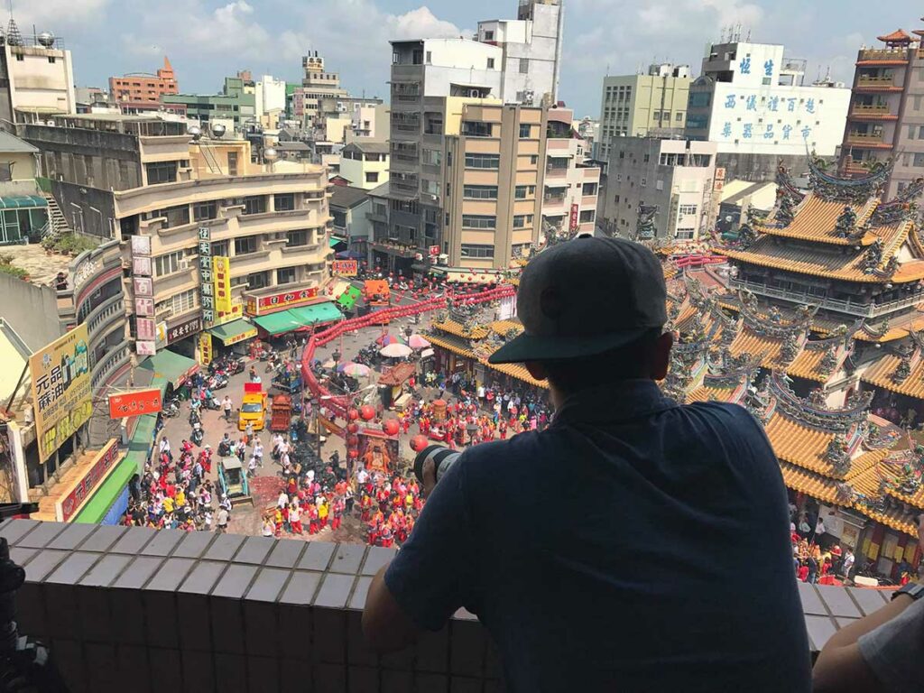 image of person on balcony looking over an event