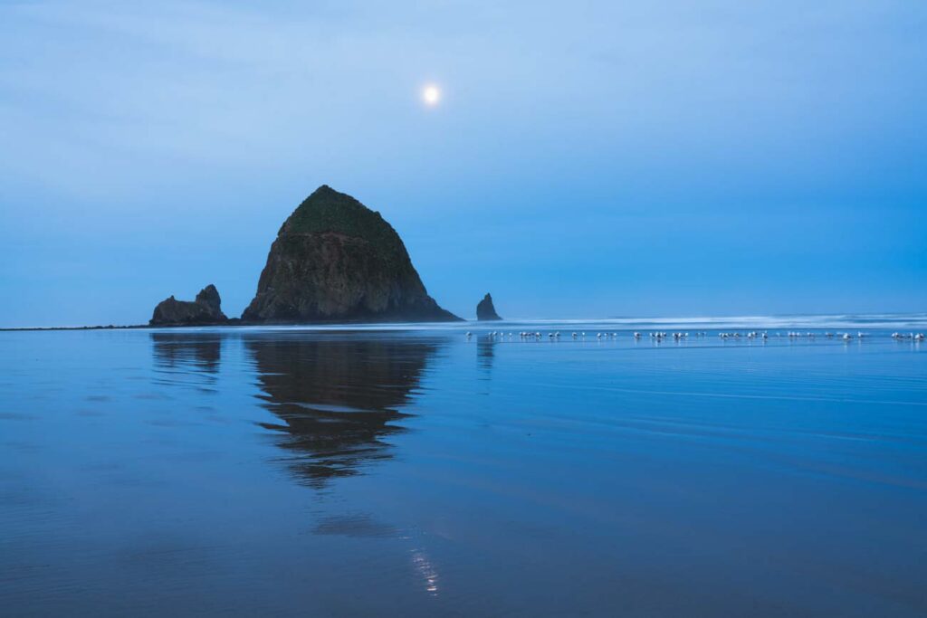 image of cannon beach haystack sunrise with moon