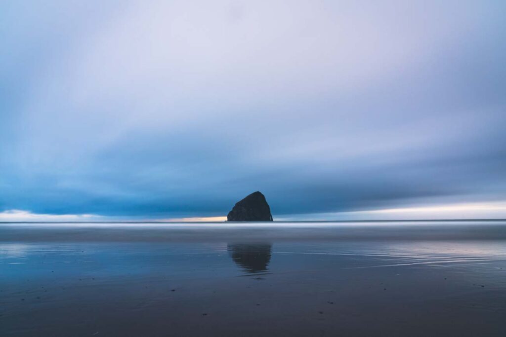 long exposure photograph of haystack rock at pacific city