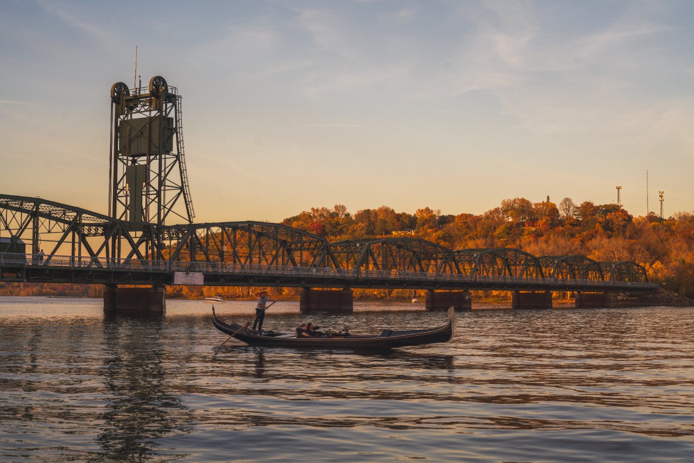 A gondola passes under the Stillwater Lift Bridge at sunset