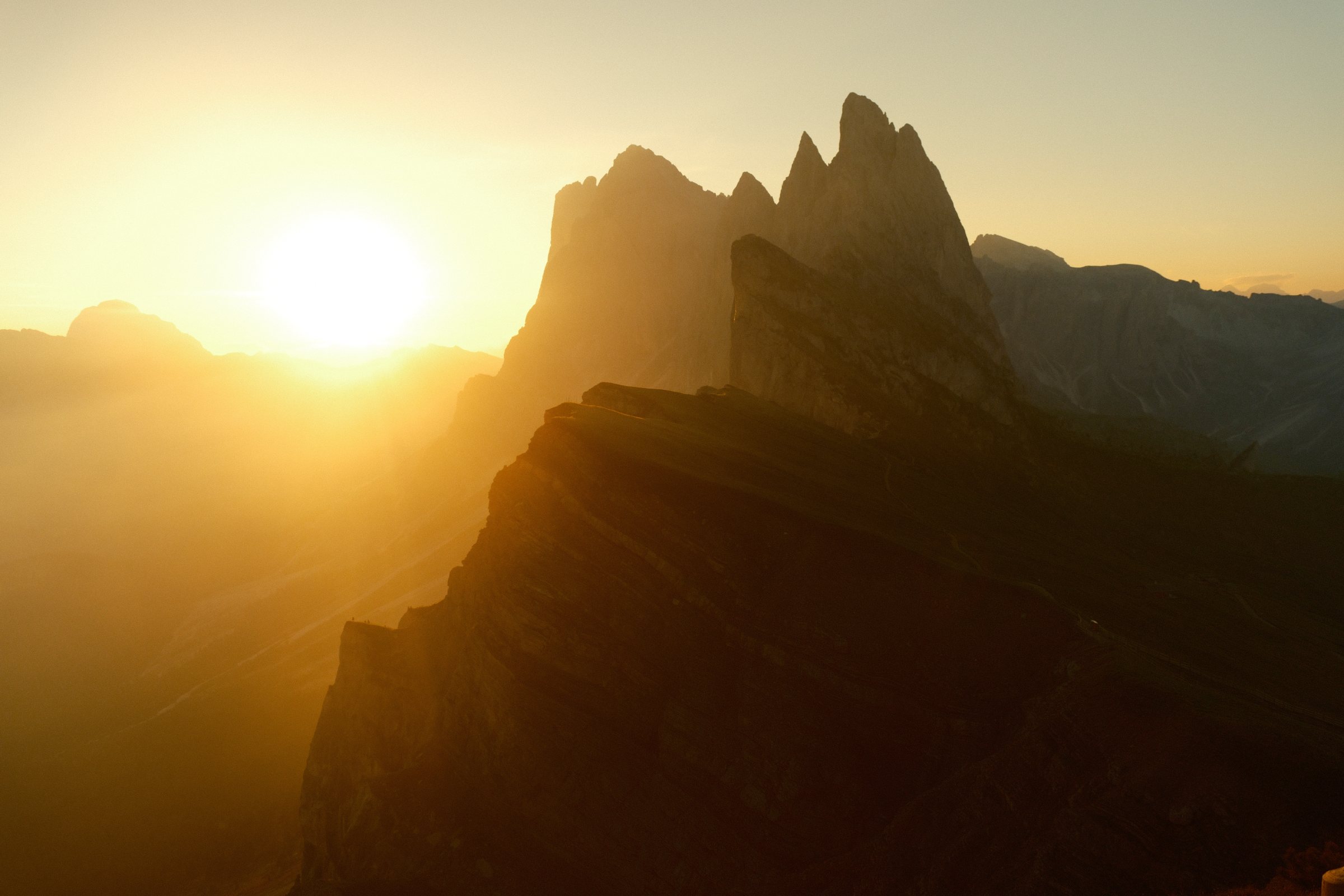 Golden sunset behind the jagged peaks of Seceda in the Dolomites